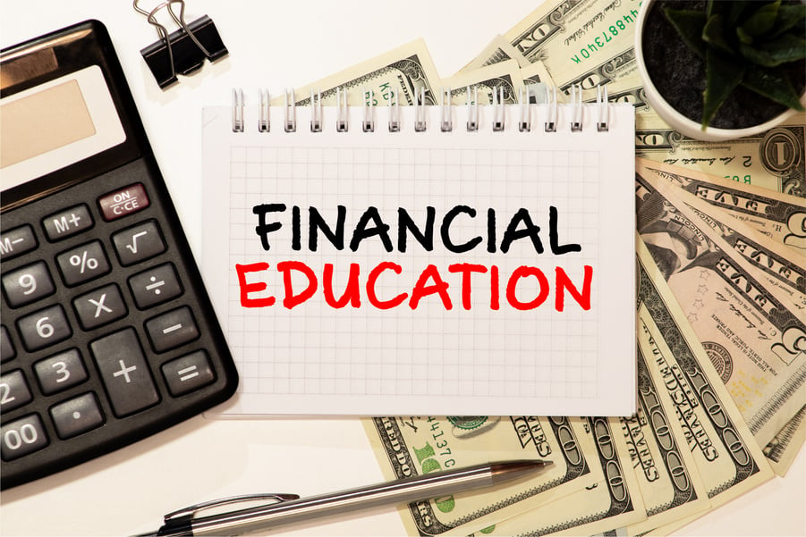 Financial Education. Businessman holding a card with a message text written on it.