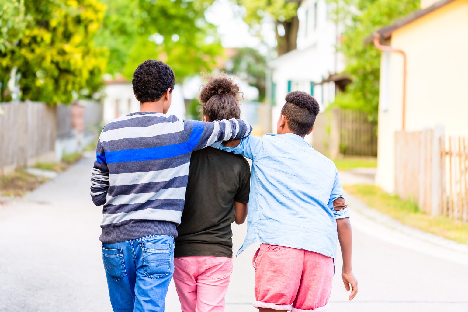 Siblings Walking down the Village Road